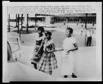 [Three African-American girls walk toward their car]