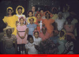 Teenagers and children wearing colorful costumes