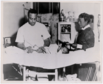 An unidentified African American physician, assisted by a nurse, treating a baby born with a club foot at an unidentified public health clinic, circa 1945