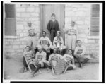 [African American baseball players from Morris Brown College, with boy and another man standing at door, Atlanta, Georgia]