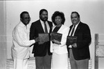 Merry Clayton posing with businessmen at the Pied Piper nightclub, Los Angeles, 1987