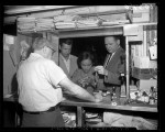 Singer Eartha Kitt with her fiance Bill McDonald and police officer recovering stolen items at pawnshop in Los Angeles, Calif., 1960