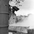 Man cooking cane syrup in an evaporator pan in Boyd, Alabama.