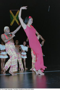 Dancers performing onstage during Ashe Caribbean event