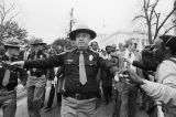 State troopers walking in front of Thomas Reed and others as they march toward the Capitol in Montgomery, Alabama, to attempt to remove the Confederate flag from atop the dome.