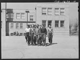 Negro schoolchildren of the Military Officers' Training Corps marching in formation for Chaplain George W. Williams, a graduate of the U. S. Army chaplain school, Fort Benjamin Harrison. The MOTC was organized at the school by teachers for those youngster