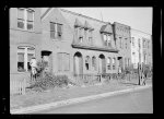 View of "blight." This fine old brick dwelling is now a shambles, housing Negro families on relief. Washington, D.C.