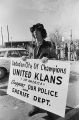 Man holding a sign for the United Klans of America in Gadsden, Alabama, the same day the UKA held a march through town.