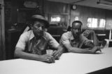 James "Son" Thomas and Joe Cooper in Leland, Mississippi. Bar, shoeshine parlor, promotional posters. (JTP 5-76-3)