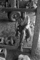 Young woman sitting in a chair inside a barn or shed near Mount Meigs in Montgomery County, Alabama.