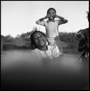 Three Young Children Smiling and Playing