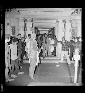 Black Boston University students carry provisions out of BU Administration Building as their 12-hour sit-in in the building ends