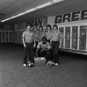 Football staff posing with equipment, 3