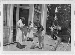 Photograph of people sweeping a storefront sidewalk, Clarkesville, Habersham County, Georgia, 1953