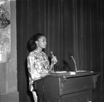 Woman at podium, Los Angeles, 1981