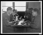 American soldiers of many races mess together and work on very close terms at a U.S. Army Quartermaster Supply Depot, Somewhere in England