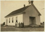 Pioneer School #13 (6 miles northwest of Shawnee) opened October 2nd--7 months term. Miss Lela Ginsinger, Principal (been here 2 years). Photo shows only 6 children present and 2 teachers in the third week of school. Expect 24 pupils. All absences are due to cotton. A few of the larger ones will be out in the Spring for cotton. Lewis W. Hine. See W.H. Swift Report.  Location: Potawotamie County, Oklahoma.