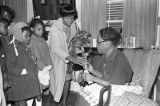 Children in the group "Buds of Promise" from Mt. Zion AME Zion Church in Montgomery, Alabama, singing to an elderly woman in her home.