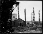 Hydrah Indian house and totem poles outside the Alaska pavilion