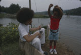 Man and little boy fishing at Oak Mountain State Park in Pelham, Alabama.