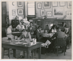 View of researchers using the Schomburg Collection, when it was the 135th Street Branch Library Division of Negro Literature, History and Prints, as it looked in 1938, with Catherine A. Latimer, reference librarian of the collection, in left background