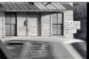 Close-up of front of Whole True Gospel Holy Church, founder pastor Elder David Harris, with passing car in foreground