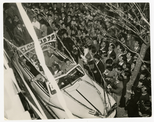 Arrival in Tokyo, Japan for Jazz at the Philharmonic tour, 1953. In the rear seat of the car, Benny Carter and Charlie Shavers. In the front middle seat, Ray Brown. [Black-and-white photoprint.]