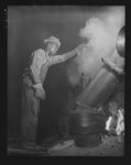 Tennessee Valley Authority production. Elemental phosphorus. A Negro worker tending an electric phosphate smelting furnace which is producing elemental phosphorus at a TVA chemical plant in the Muscle Shoals area. The phosphorus, used in the manufacture of incendiary bombs and shells and of material for "smoke," is produced by smelting phosphate rock, coke and silica together in the electric furnaces and condensing the resulting phosphorus gases. When surplus phosphorus is available it is converted into highly concentrated phosphate fertilizer, much of which is shipped abroad under provisions of the Lend-Lease Bill