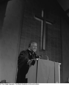 Reverend Marshall E. Hodge standing at podium