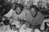 Barbara Howard Flowers and Robert Flowers seated with others at a table at a club, probably in Montgomery, Alabama.