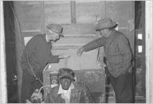 African-American Man And Two Men Looking At Feed