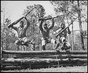 "A trio of recruits in training to take their places as fighting Leathernecks in the U.S. Marine Corps, run the rugged obstacle course at Camp Lejeune, NC [Montford Point Camp]. The Marine recruits have shown such excellent results in their aptitudes and leadership capacities that an expanded Navy recruiting program is now underway."