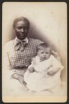 [Young African American woman holding a baby]