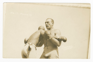 Photographic postcard of Jack Johnson and James J. Jeffries clinching