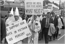 Klansmen and other marchers carrying signs in a parade during a Ku Klux Klan rally in Montgomery, Alabama.