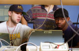 Engineering students look at computer together in a lab, 1996