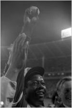 Hank Aaron holds up the 715th home run baseball after breaking the record, 1974