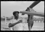 Negro stevedore handling lumber in unloading process, Pilottown, Louisiana, the "El Rito"