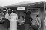 Black Agenda Business Fair participants standing at a booth, Los Angeles, 1983