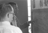 Young man from Bessemer High School discussing a math problem with his tutor in the basement of St. Paul's Lutheran Church in Birmingham, Alabama.