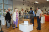 Roger Smith talks with attendees at exhibit opening