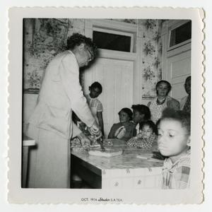 Women and Children Watching a Cooking Demonstration