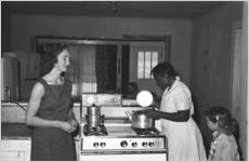 African American woman and woman and girl in kitchen