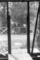 Young men sitting on or standing around a wooden fence in Newtown, a neighborhood in Montgomery, Alabama.