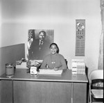 Bradley campaign staff member posing at a desk, Los Angeles, 1973