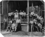 Conference[?], Harper's Ferry, West Virginia, ca. 1915. Jesse Moorland on left sitting on steps holding cap; William Hunton is two rows above Moorland wearing hat; Max Yergan is on the right, leaning against post; Channing Tobias sitting on right step...