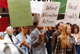 Bakke Decision Protest depicting people marching and holding protest signs in Seattle, Washington, 1977