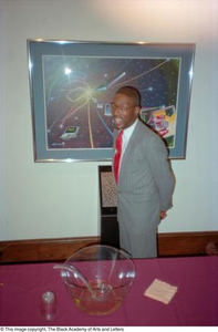 Unidentified man standing in front of cosmic painting