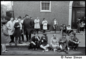 White student supporters of Umoja (Black student union) activists seated on sidewalk, with onlookers behind, during occupation of administration building, Boston University