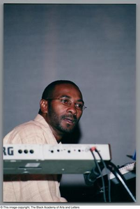 Medium shot of music director and keyboardist Eric Willis